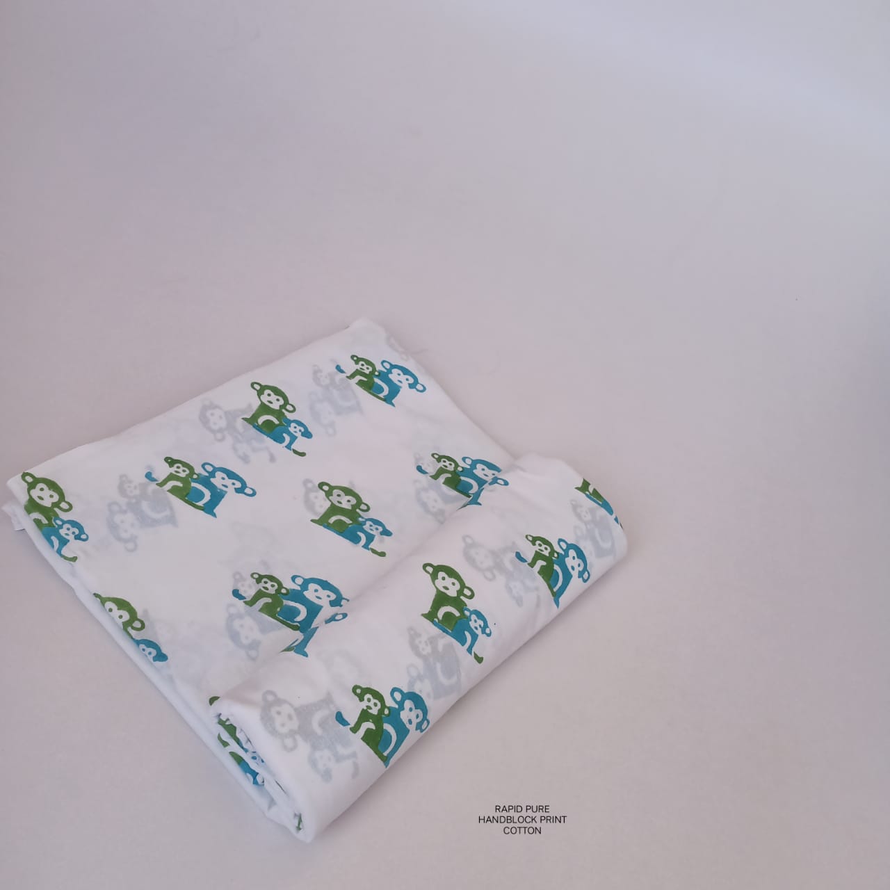 Wholesale Jaipur Sanganeri Handblock Cotton Fabric in white and green featuring monkey butti print, ideal for boutiques, designers, and retailers.